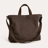 Sac cabas bandoulière en toile gris — posé sur meuble