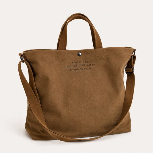 Sac cabas bandoulière en toile marron — posé sur meuble