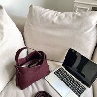 Sac cabas daim compact femme rouge ouvert près d’un ordinateur