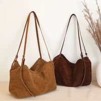 Sacs cabas daim souple femme marron et café posés côte à côte