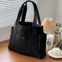 Sac cabas large en toile noir — posé sur meuble